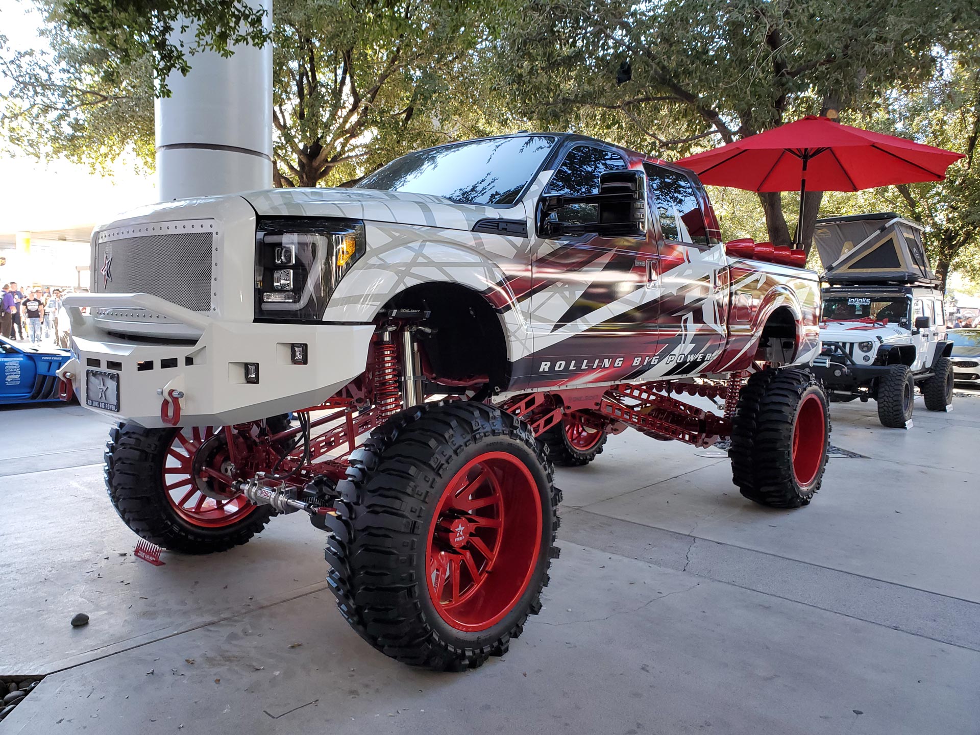 A White and Red Truck With Red Tires