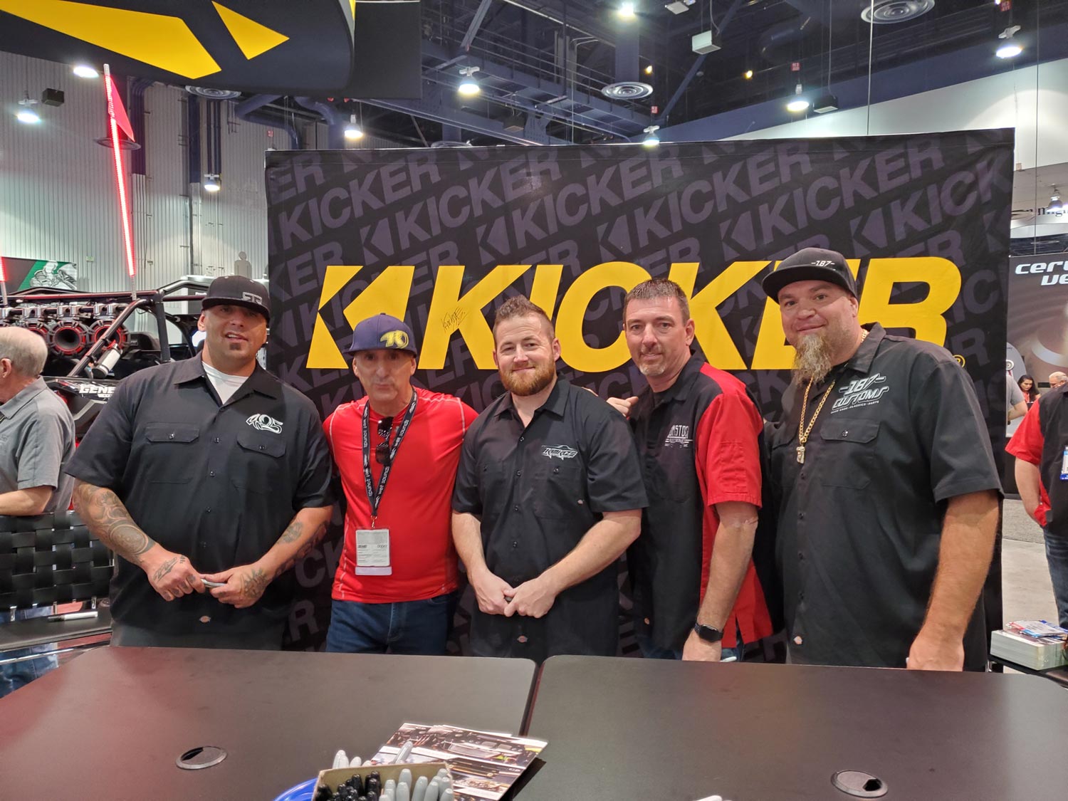 Five Person Standing Infront of Kicker Logo
