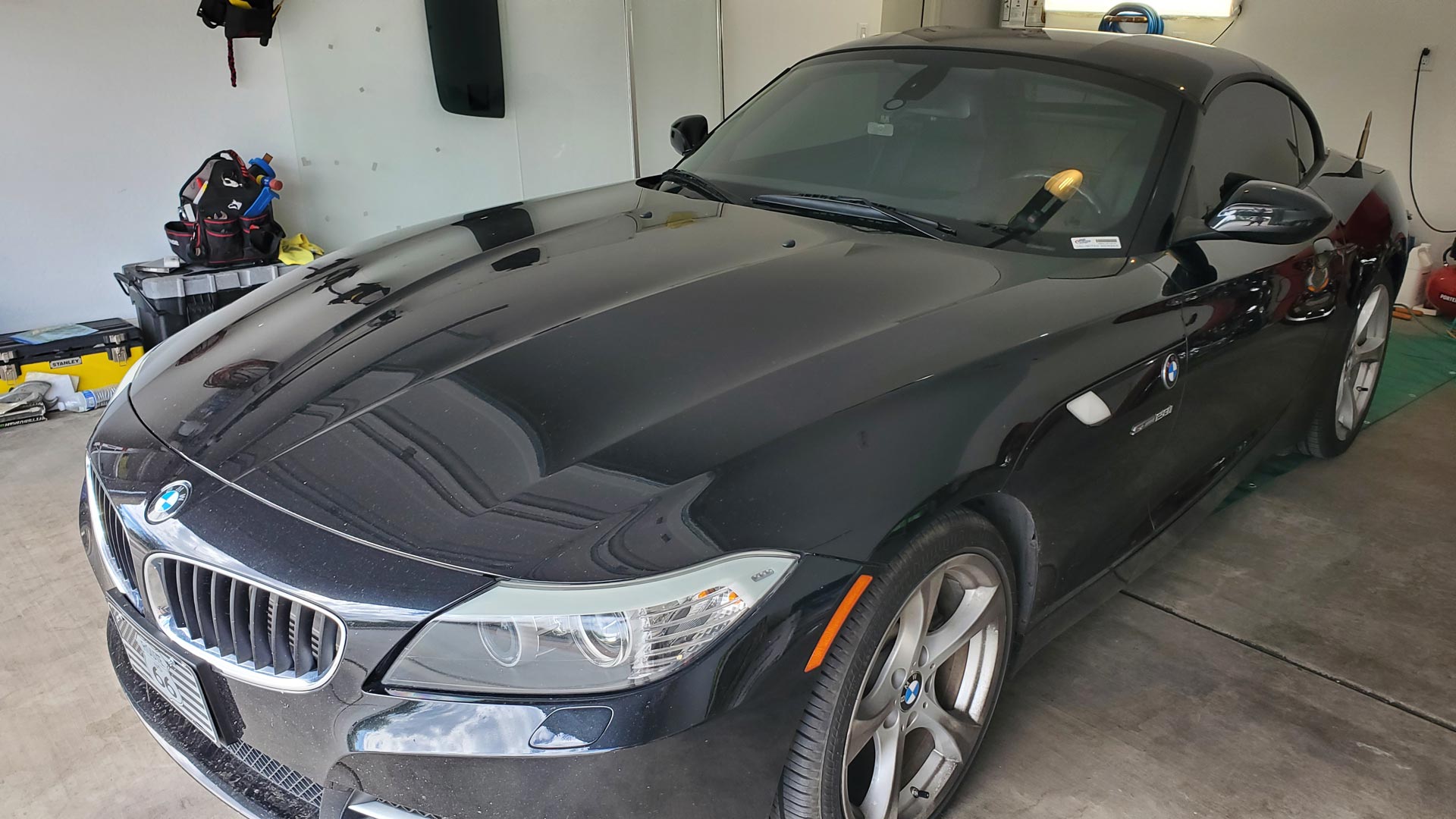 A Black BMW Z4 Parked in a Garage
